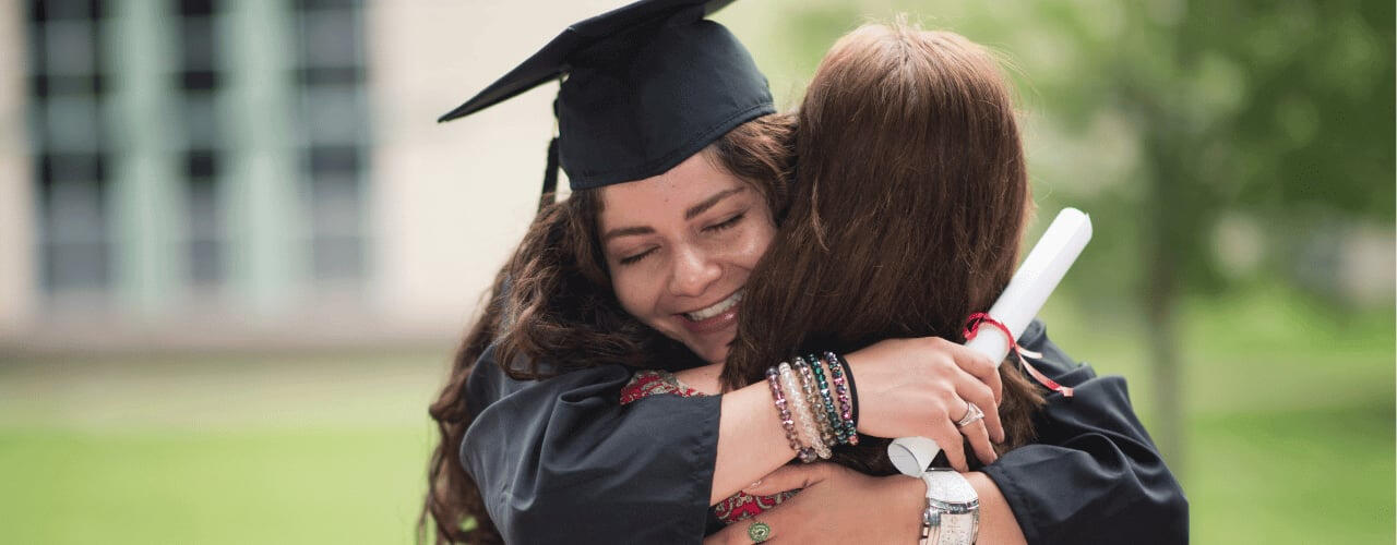 daughter-hugging-mother-in-celebration-of-her-degree-with-the-